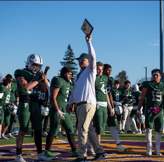 Head coach D. DeGeronimo holds up CCS title.